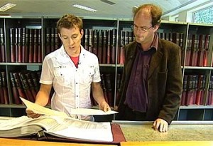 Two men looking at some archives in the family records centre
